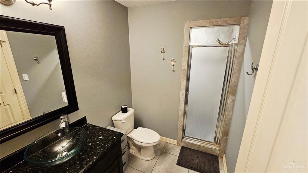 4711 North Stewart Road Palmhurst, TX 78573 - Photo 27 of 40 a bathroom with a toilet and a mirror
