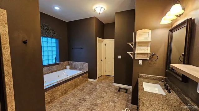 a bathroom with a tub sink and mirror