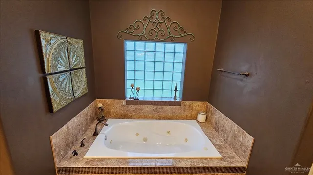 a bath tub sitting in a bathroom next to a window