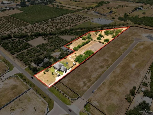 an aerial view of house with yard