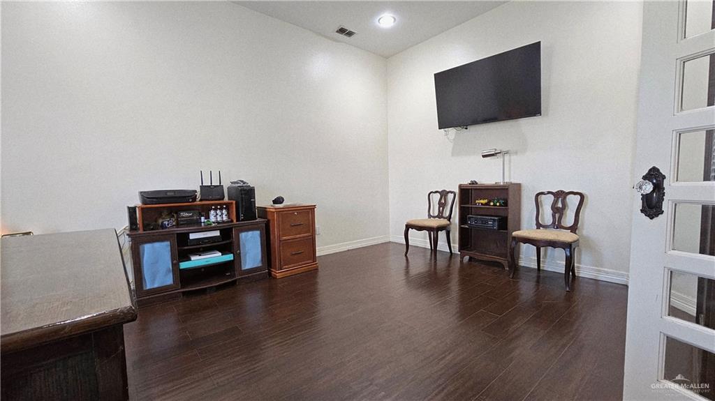 4711 North Stewart Road Palmhurst, TX 78573 - Photo 9 of 40 a living room with furniture and a flat screen tv