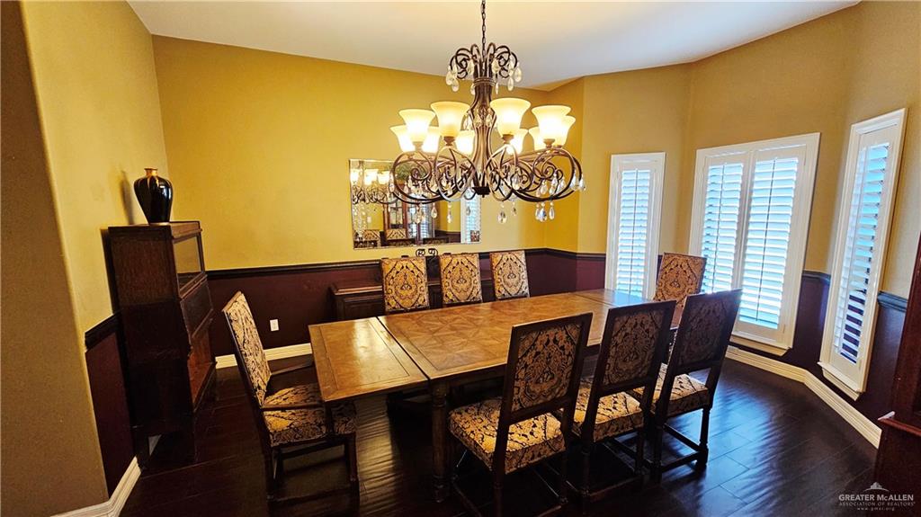 4711 North Stewart Road Palmhurst, TX 78573 - Photo 10 of 40 a view of a dining room with furniture and chandelier