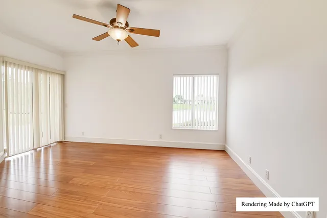 an empty room with a window and a ceiling fan