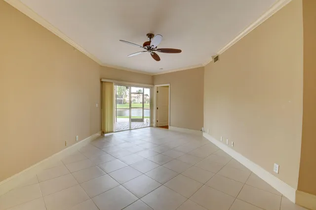 a view of a livingroom with a ceiling fan and window