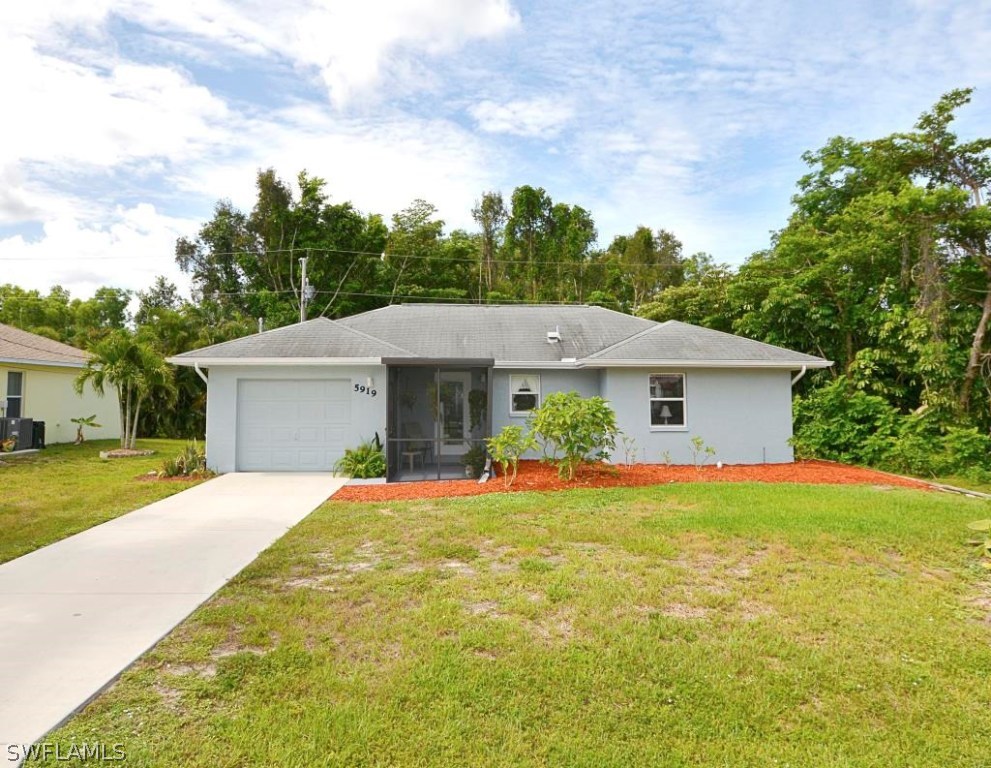 5919 Mackerel Road Bokeelia, FL 33922 - Photo 1 of 27 a front view of house with yard and trees in the background