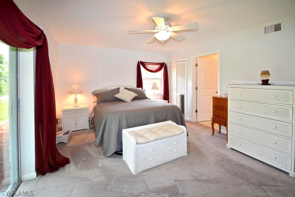 5919 Mackerel Road Bokeelia, FL 33922 - Photo 11 of 27 a bedroom with a bed and a chandelier