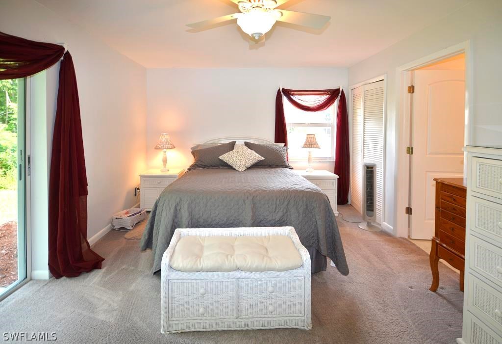 5919 Mackerel Road Bokeelia, FL 33922 - Photo 12 of 27 a bedroom with a bed and a painting on the wall