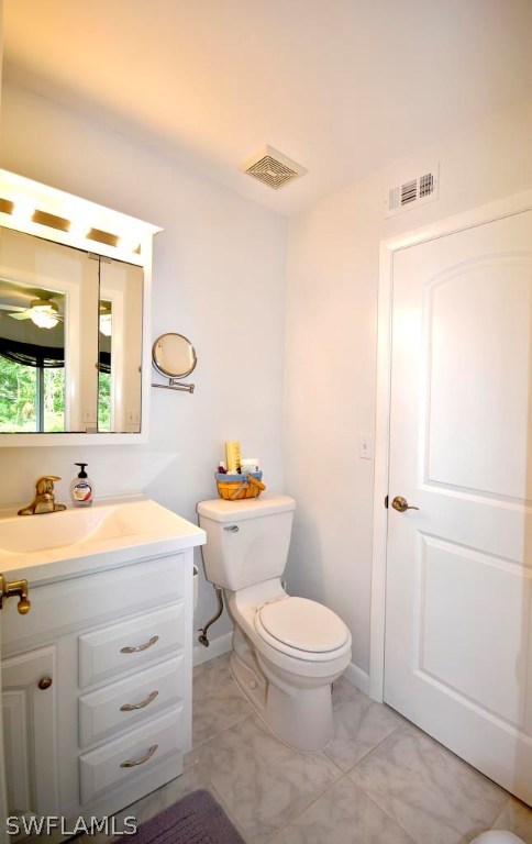 5919 Mackerel Road Bokeelia, FL 33922 - Photo 13 of 27 a bathroom with a toilet a sink and a mirror