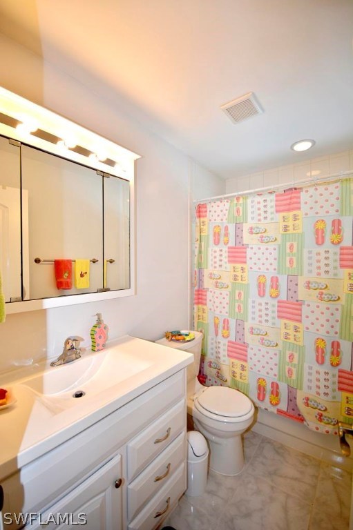 5919 Mackerel Road Bokeelia, FL 33922 - Photo 14 of 27 a bathroom with a granite countertop sink mirror vanity and toilet