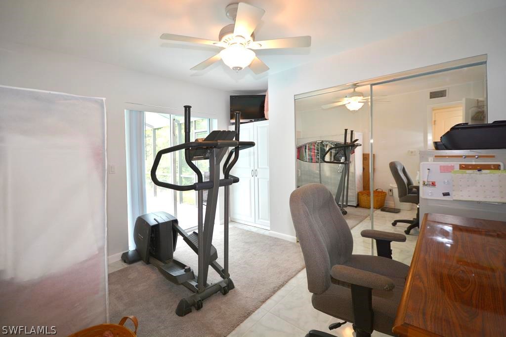 5919 Mackerel Road Bokeelia, FL 33922 - Photo 15 of 27 a view of a livingroom with furniture and a gym equipment