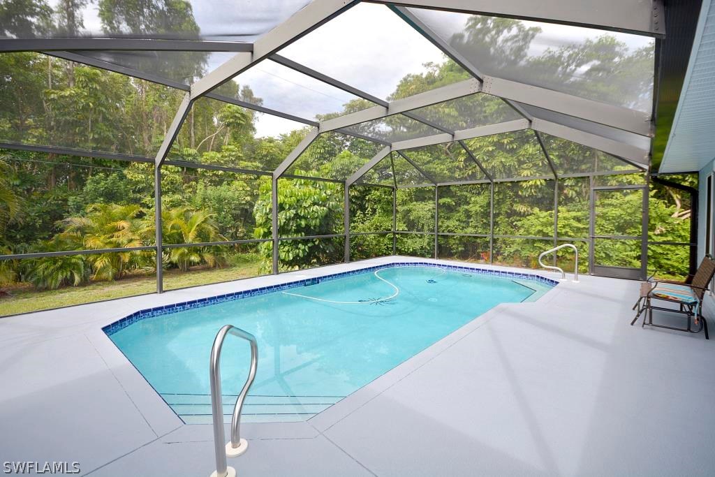 5919 Mackerel Road Bokeelia, FL 33922 - Photo 21 of 27 a view of a swimming pool with a yard and sitting space