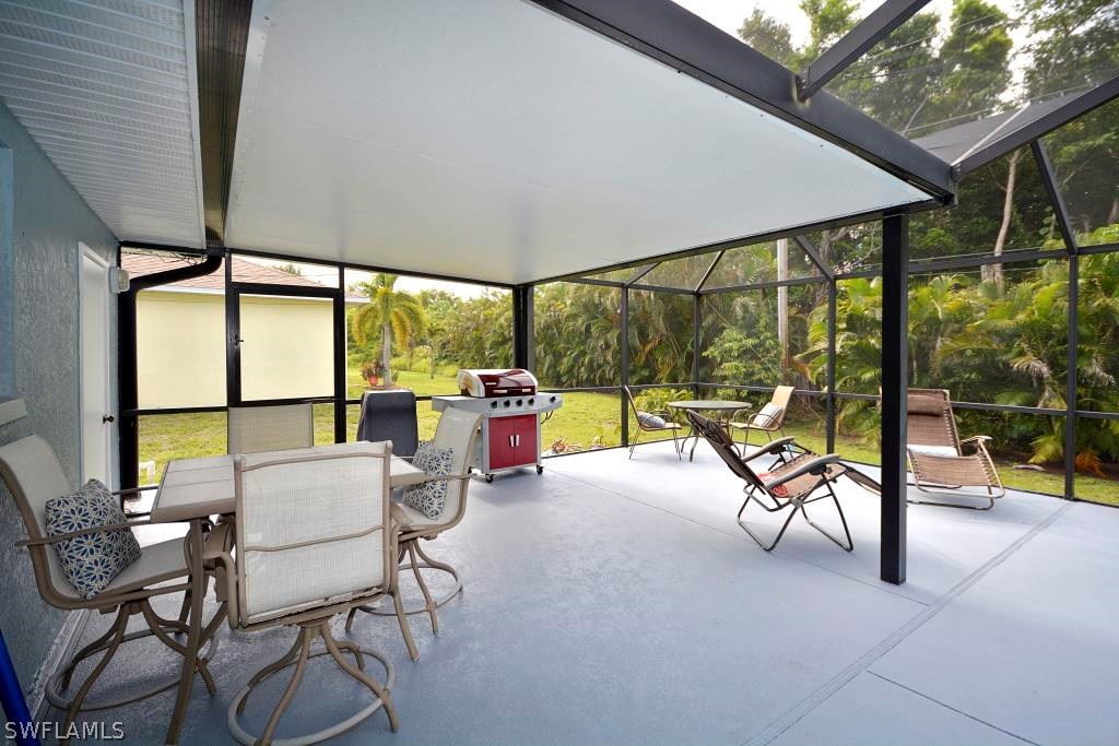 5919 Mackerel Road Bokeelia, FL 33922 - Photo 23 of 27 a building outdoor space with patio furniture and glass door