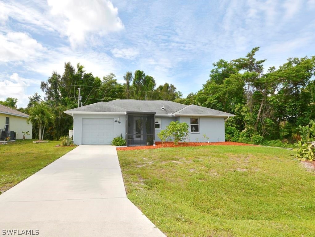 5919 Mackerel Road Bokeelia, FL 33922 - Photo 27 of 27 a house view with a garden space
