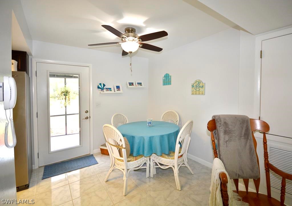 5919 Mackerel Road Bokeelia, FL 33922 - Photo 5 of 27 a view of a dining room with furniture and window