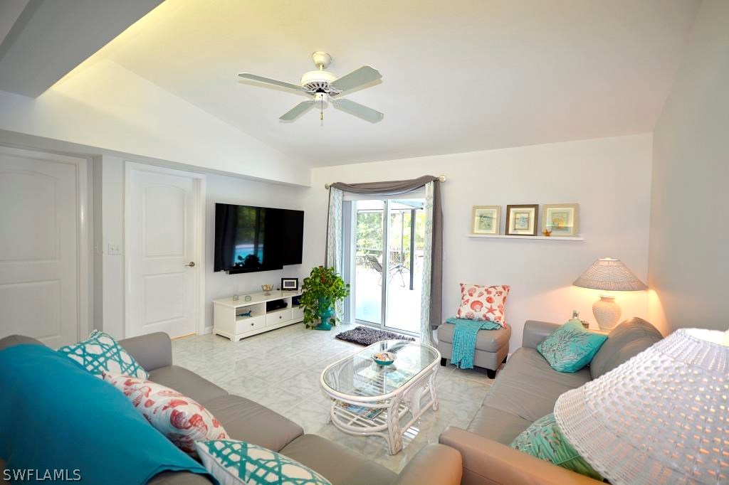 5919 Mackerel Road Bokeelia, FL 33922 - Photo 7 of 27 a living room with furniture and a flat screen tv