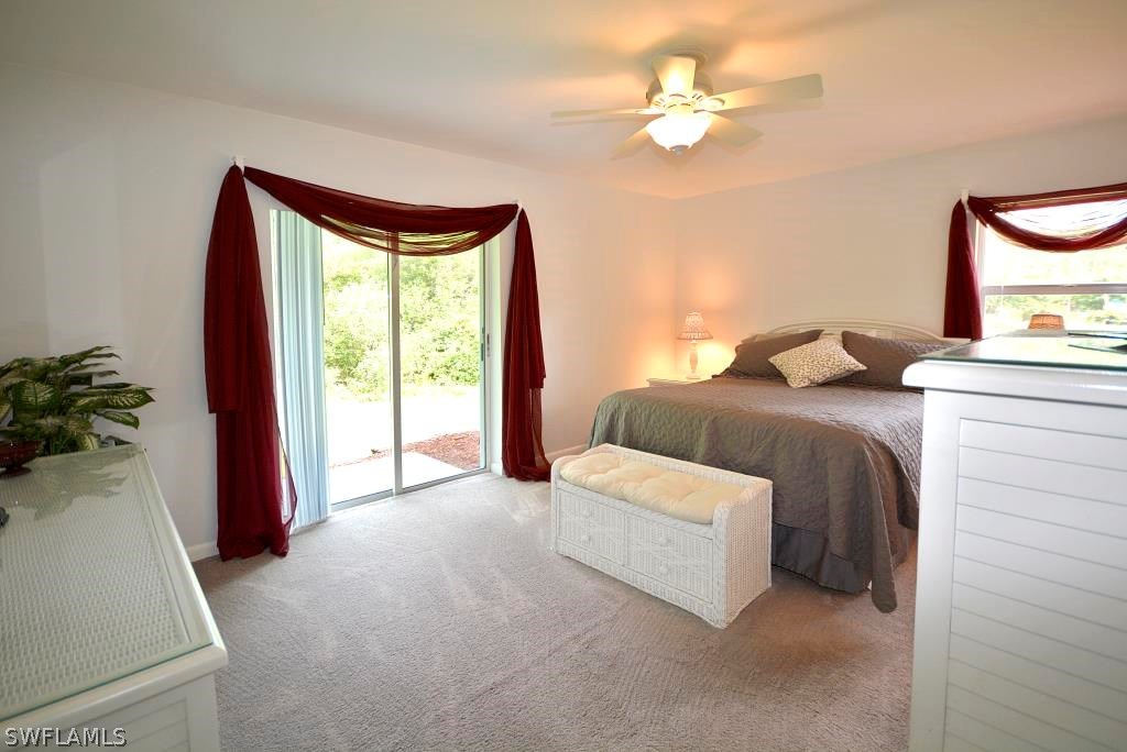 5919 Mackerel Road Bokeelia, FL 33922 - Photo 10 of 27 a bedroom with a bed and a chandelier