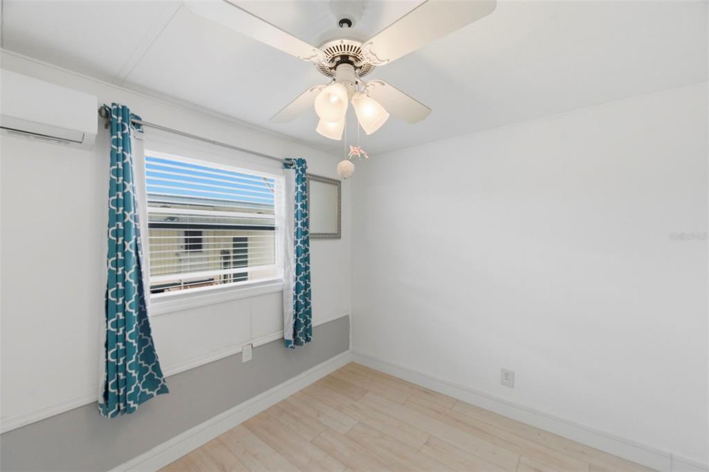 10810 Freedom Drive Port Richey, FL 34668 - Photo 23 of 65 wooden floor in an empty room with a window