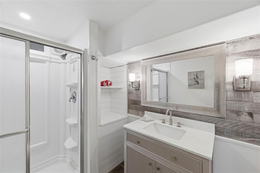 10810 Freedom Drive Port Richey, FL 34668 - Photo 28 of 65 a bathroom with a sink mirror toilet and shower