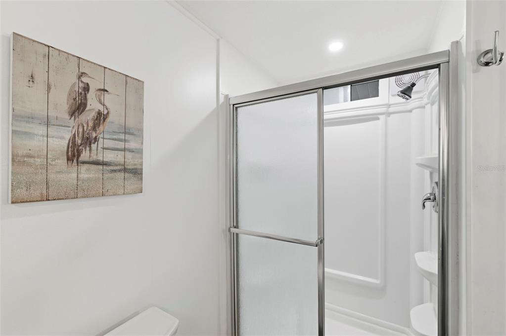 10810 Freedom Drive Port Richey, FL 34668 - Photo 29 of 65 a bathroom with a shower and a mirror