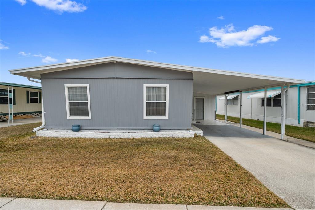 10810 Freedom Drive Port Richey, FL 34668 - Photo 3 of 65 front view of a house with a big yard