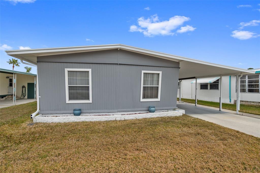 10810 Freedom Drive Port Richey, FL 34668 - Photo 32 of 65 a view of a house with a backyard and a tree