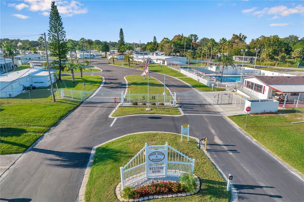 10810 Freedom Drive Port Richey, FL 34668 - Photo 50 of 65 a view of a swimming pool with a garden