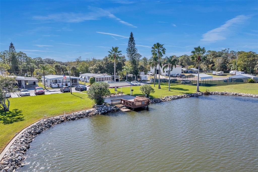 10810 Freedom Drive Port Richey, FL 34668 - Photo 54 of 65 a view of a swimming pool with outdoor seating and yard in the back