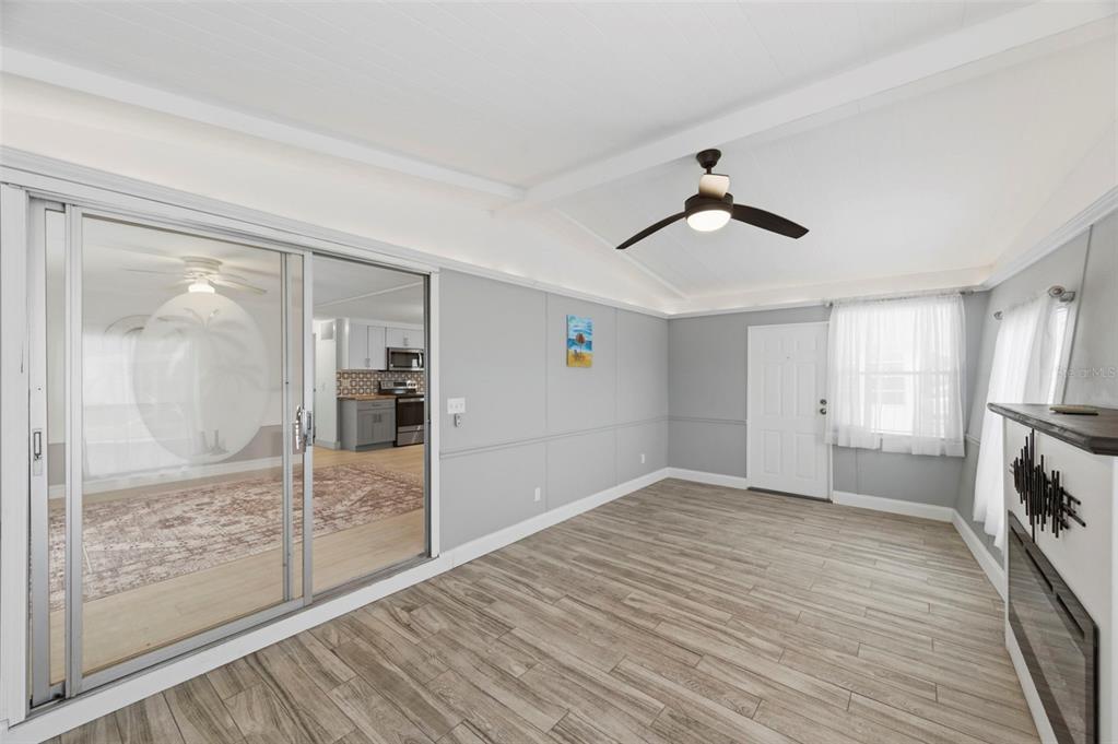 10810 Freedom Drive Port Richey, FL 34668 - Photo 7 of 65 a view of empty room with wooden floor and fan