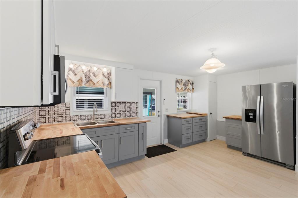 10810 Freedom Drive Port Richey, FL 34668 - Photo 9 of 65 a large kitchen with a sink and cabinets