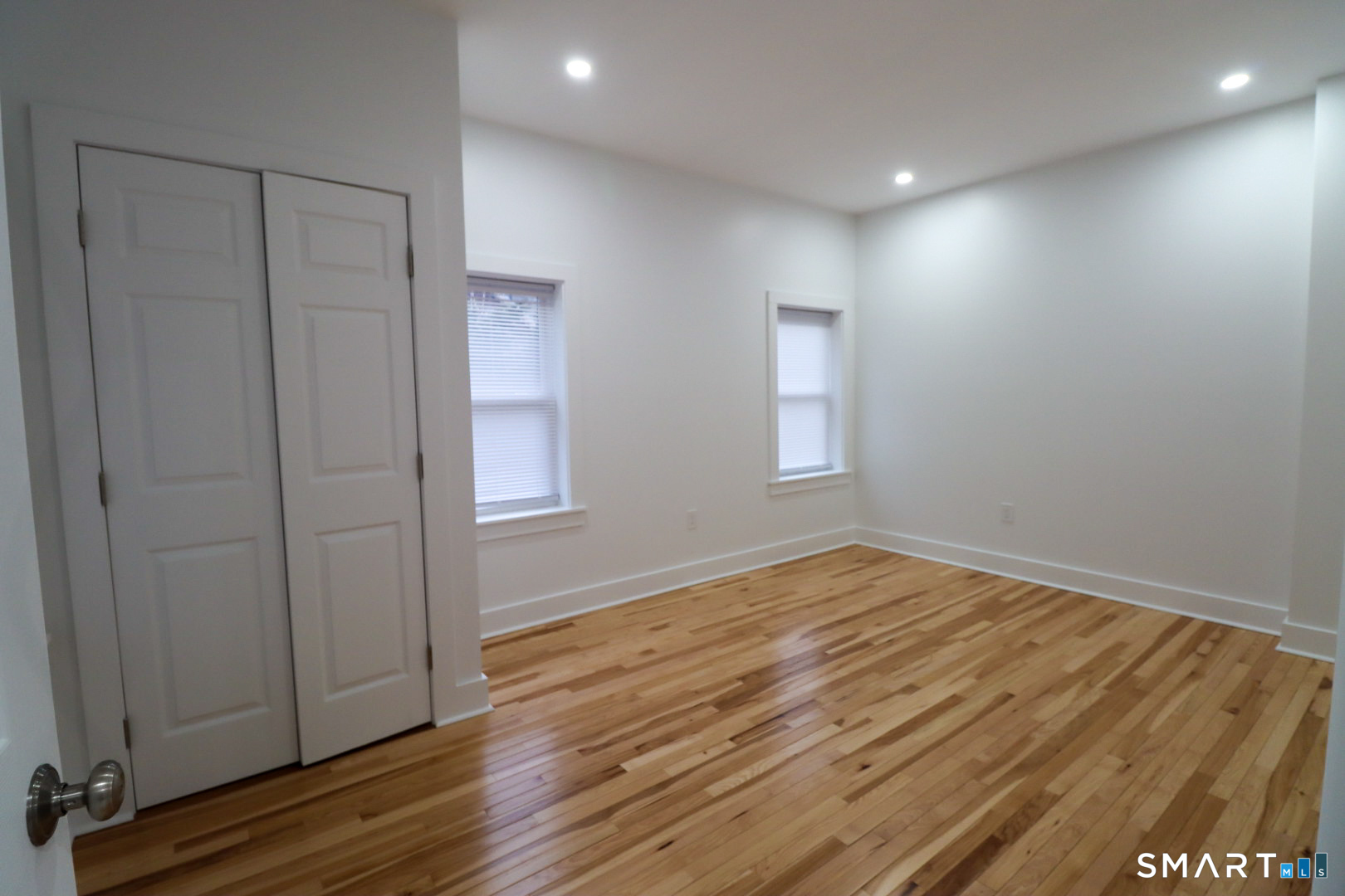 55 Channing Street, Unit 2 New London, CT 06320 - Photo 11 of 19 an empty room with wooden floor and windows