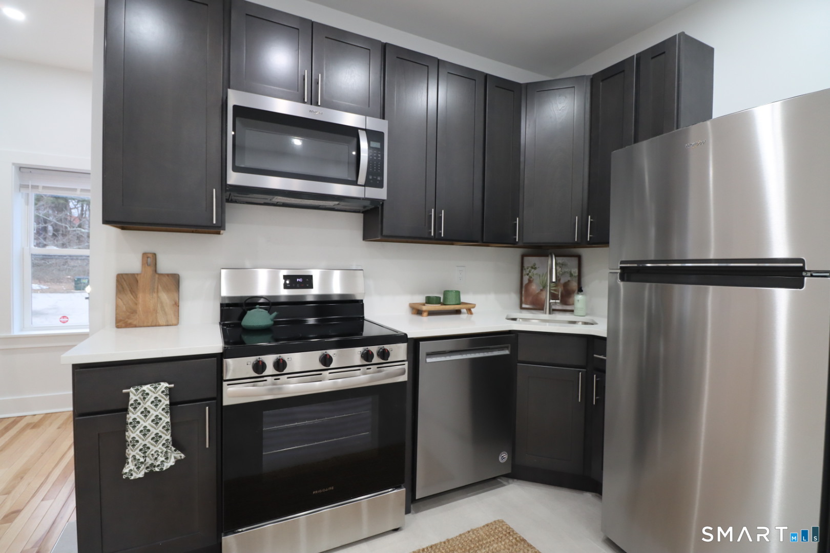 55 Channing Street, Unit 2 New London, CT 06320 - Photo 3 of 19 a kitchen with stainless steel appliances granite countertop a stove a refrigerator and a microwave