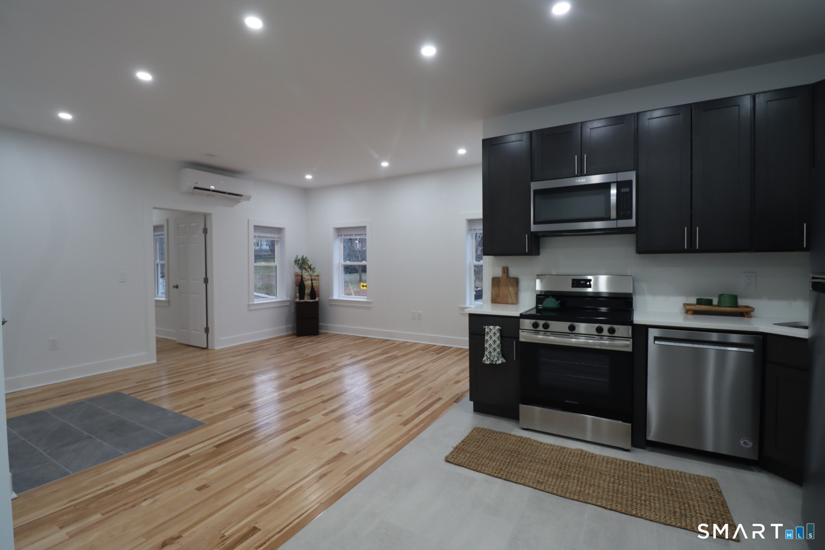 55 Channing Street, Unit 2 New London, CT 06320 - Photo 5 of 19 a kitchen with stainless steel appliances granite countertop a stove a refrigerator and a microwave
