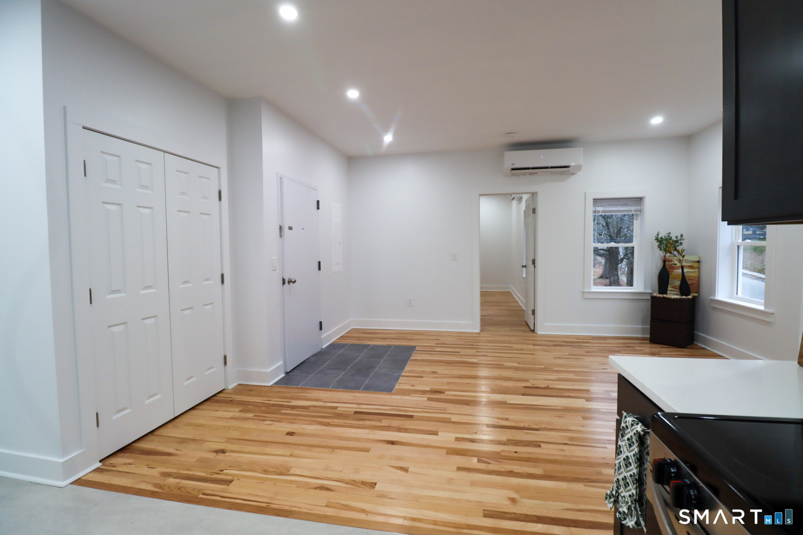 55 Channing Street, Unit 2 New London, CT 06320 - Photo 6 of 19 a view of a kitchen with kitchen island a sink wooden floor and a refrigerator