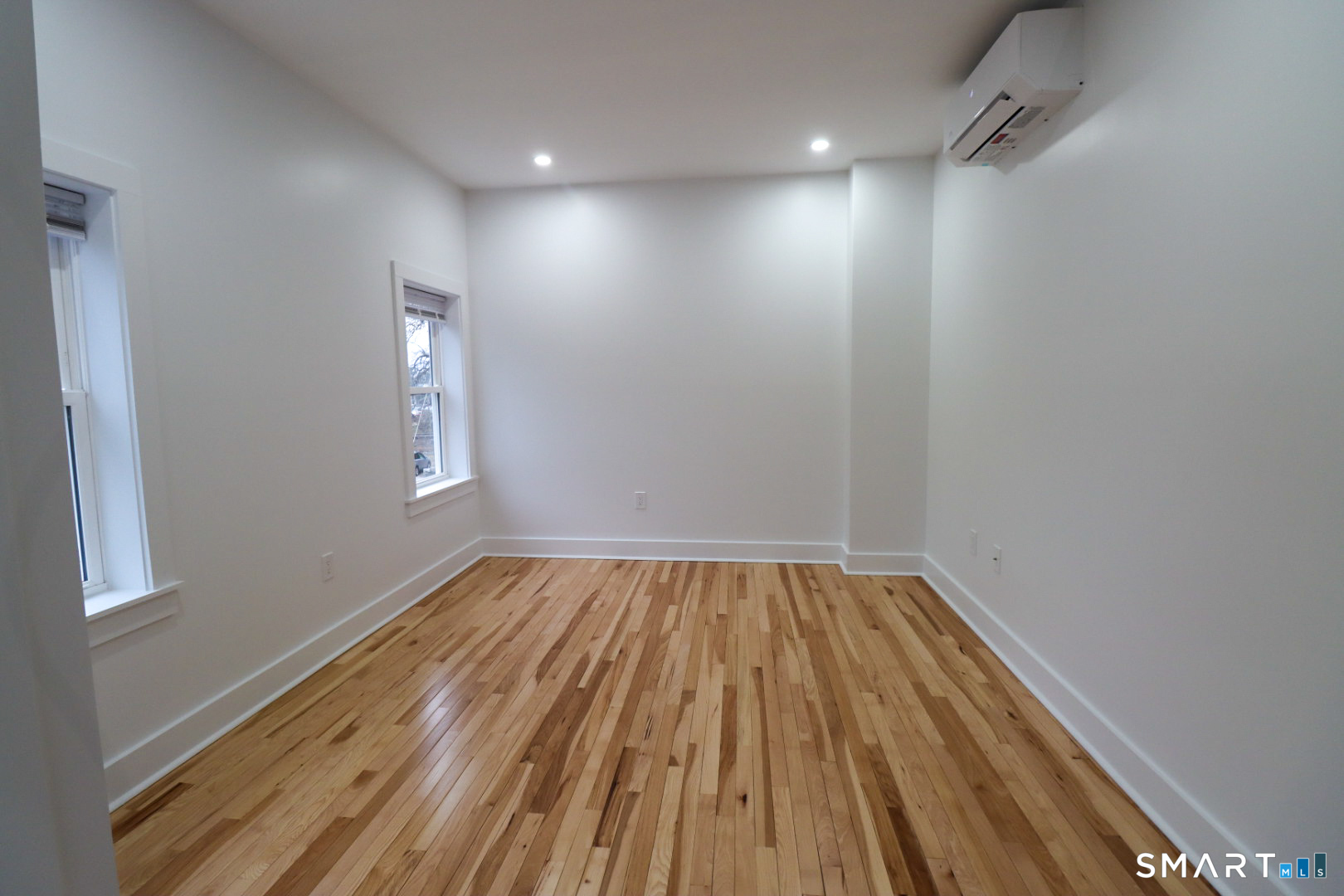 55 Channing Street, Unit 2 New London, CT 06320 - Photo 7 of 19 a view of empty room with wooden floor and fan