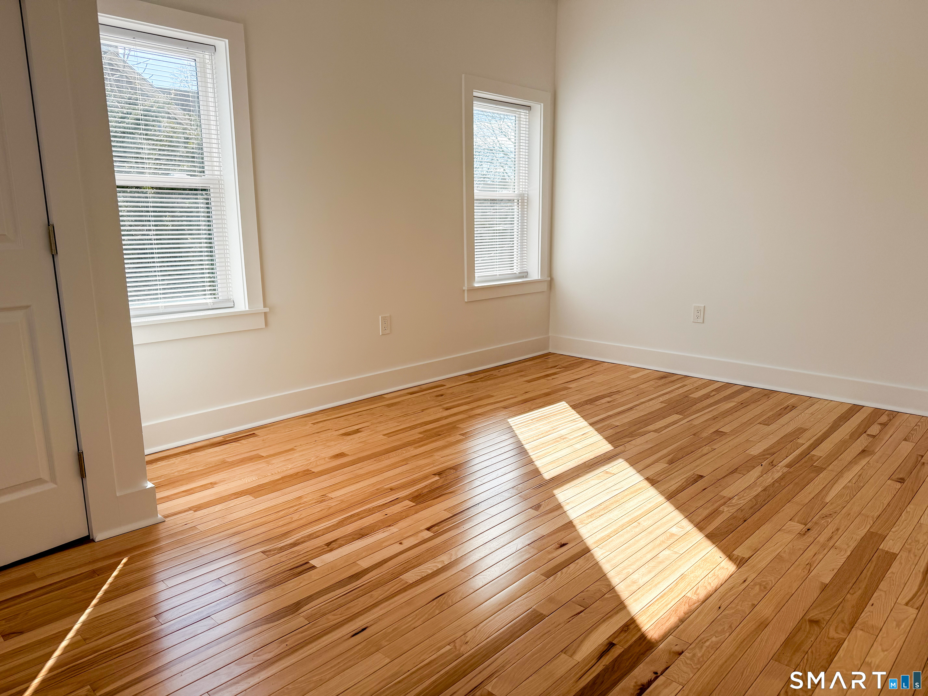55 Channing Street, Unit 2 New London, CT 06320 - Photo 10 of 19 a view of an empty room and wooden floor and a window