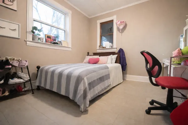 a bedroom with bed and a window