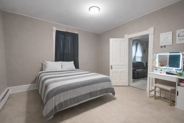 a bedroom with a bed and a view of kitchen