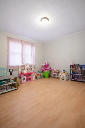 a view of a room with a baby crib and a couch