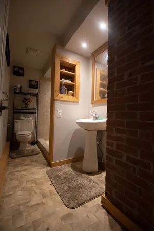 a bathroom with a sink toilet and shower