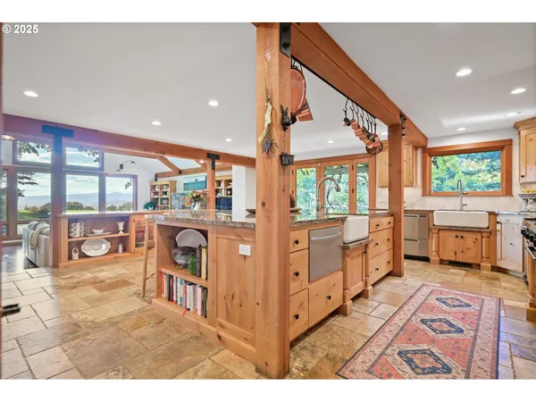 a open kitchen with stainless steel appliances kitchen island granite countertop a refrigerator a stove and a sink