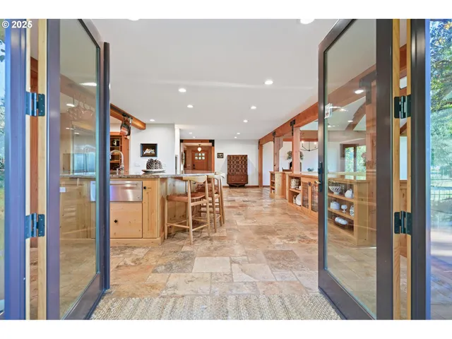 a sitting area with large glass windows