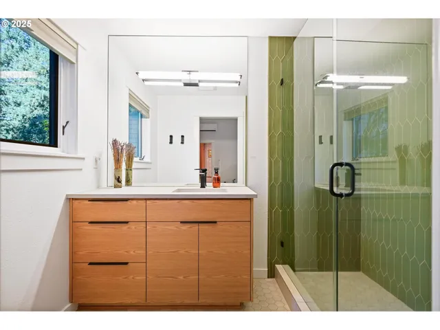 a view of a hallway with wooden floor and a living room