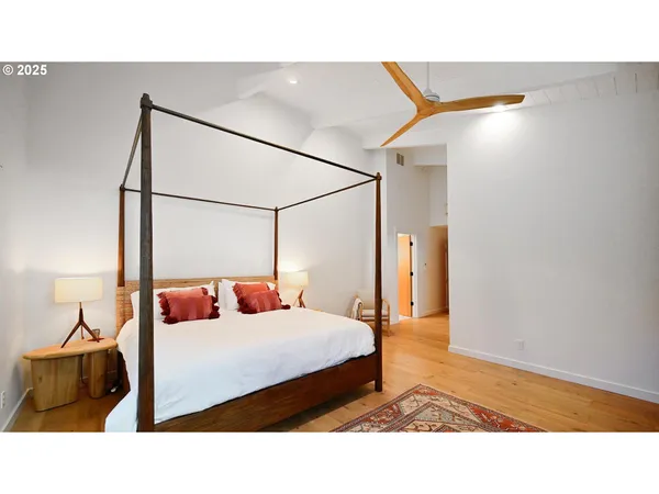 a bedroom with a bed and a television