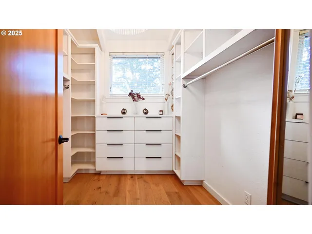 a living room with stainless steel appliances kitchen island granite countertop a sink and cabinets