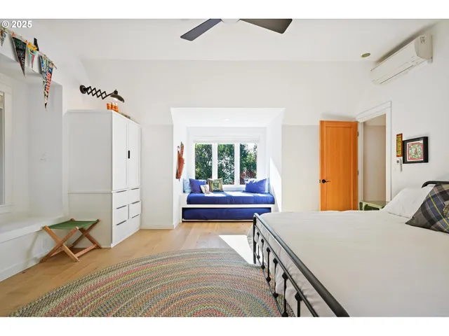 a living room with furniture a wooden floor and next to a window