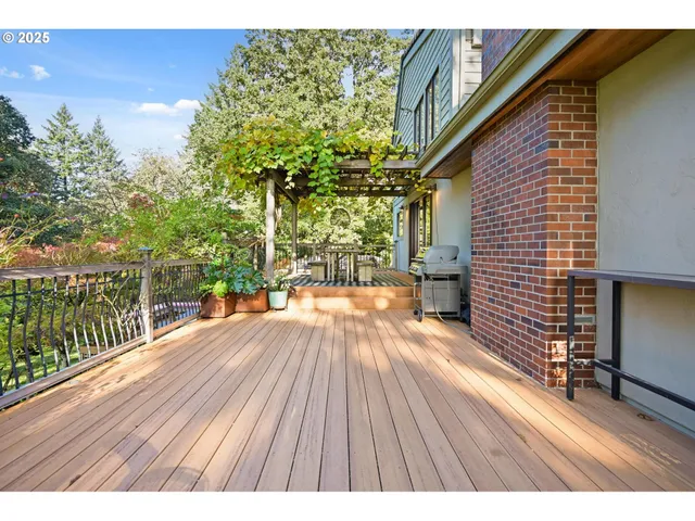 a view of patio with table and chairs wooden floor and fence