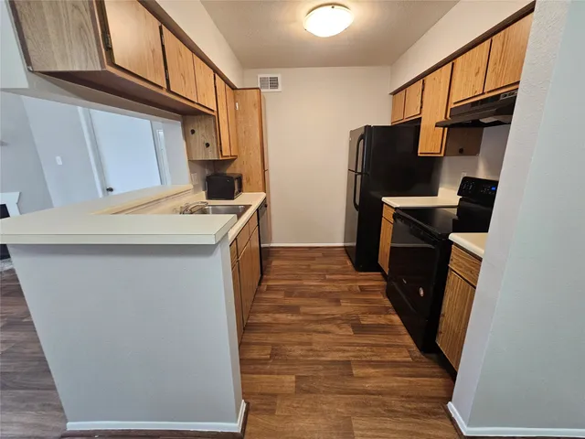 a kitchen with a sink stove and refrigerator