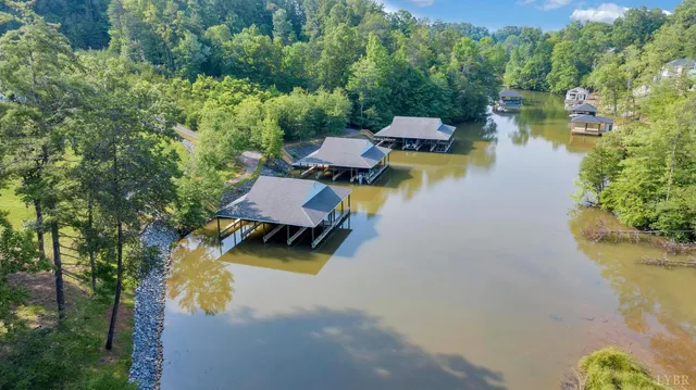 an aerial view of a house with swimming pool and lake view