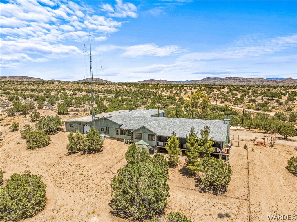 2401 North Stephan Road Kingman, AZ 86401 - Photo 8 of 92 Extensive desert landscape featuring a sprawling single-story residence with a multi-gabled roofline and an attached garage