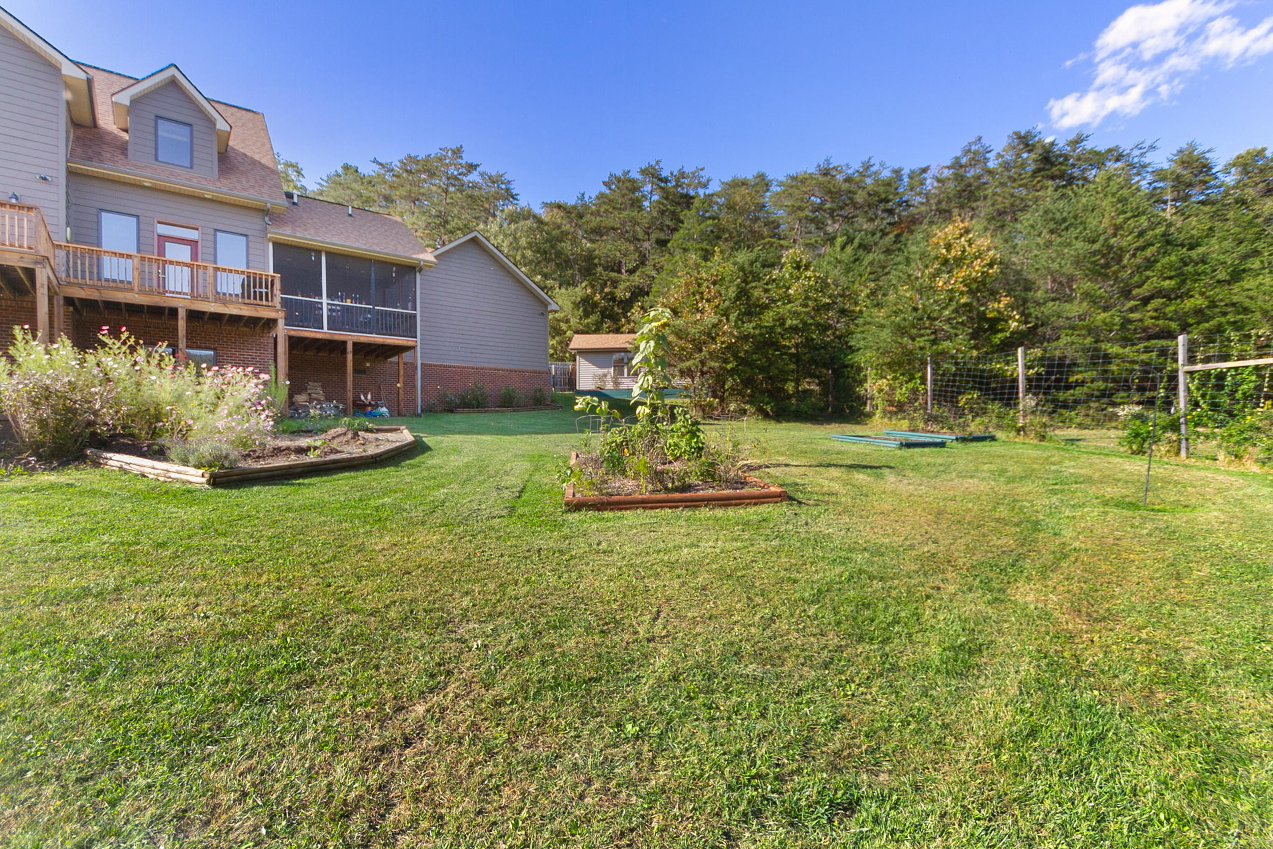 3950 Flatwoods Road Elliston, VA 24087 - Photo 3 of 94 a view of a house with a yard and sitting area